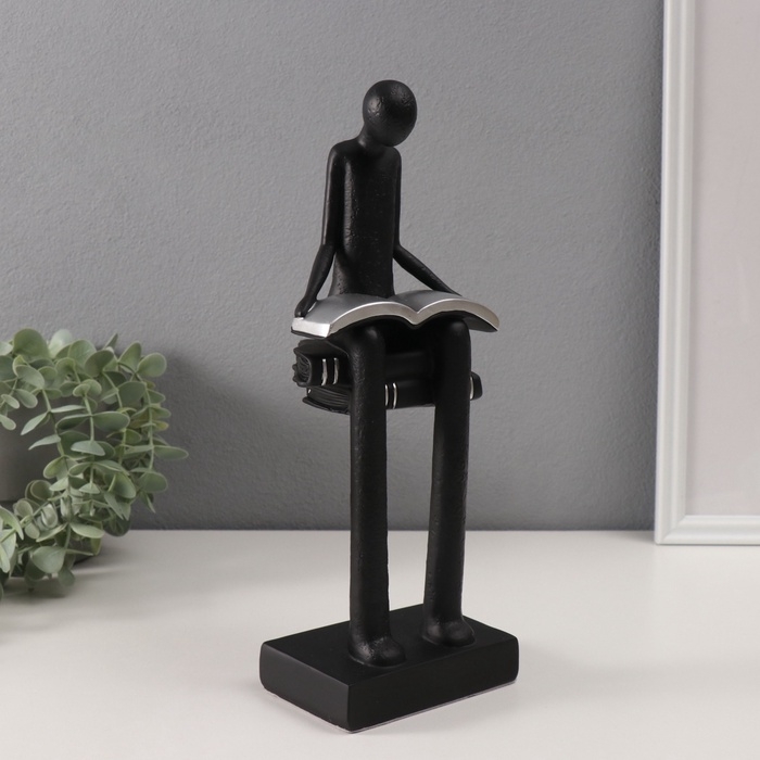 Сувенир полистоун  Сувенир полистоун "Абстракция. Человек сидит на книгах читает" черный с серебром 7,5х11х30см