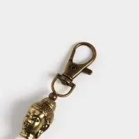 Брелок-кисточка "Будда" 17 см, цв. белый, золотистый Брелок-кисточка "Будда" 17 см, цв. белый, золотистый