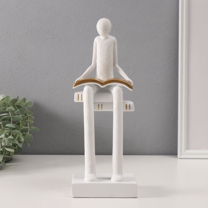 Сувенир полистоун  Сувенир полистоун "Абстракция. Человек сидит на книгах читает" белый с серебром 7,5х11х30 см   10686