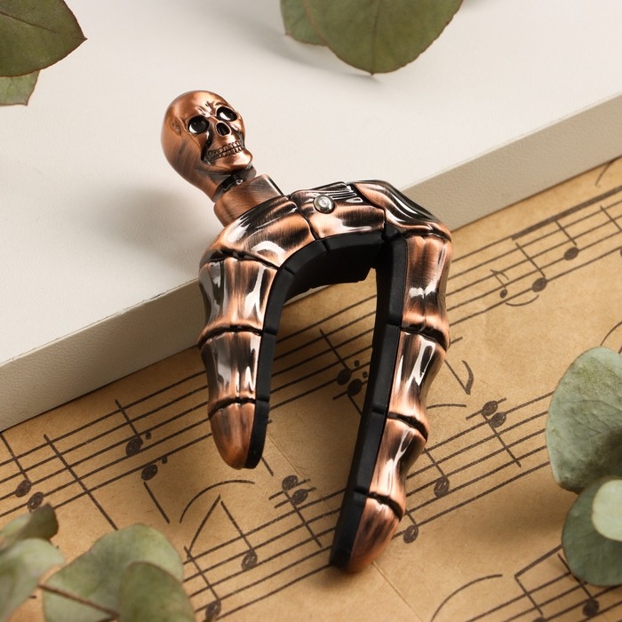 Каподастр для гитары Music Life Череп, бронзовый Каподастр для гитары Music Life Череп, бронзовый