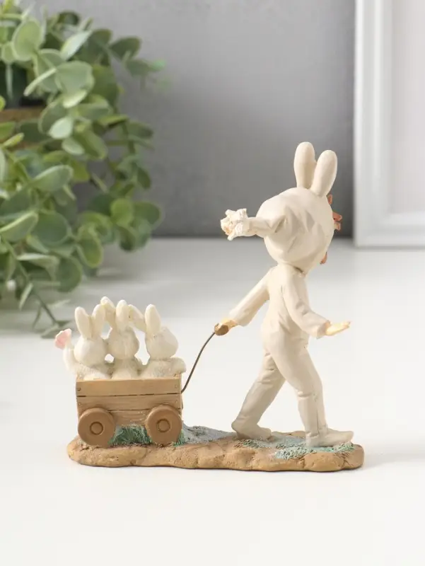Сувенир полистоун "Девочка в комбинезоне с заячьими ушами, везет тележку с зайцами" 13,5 см   109278