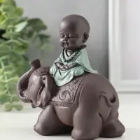 Сувенир полистоун "Маленький будда на слоне" зелёно-коричневый 5,5х12х12 см